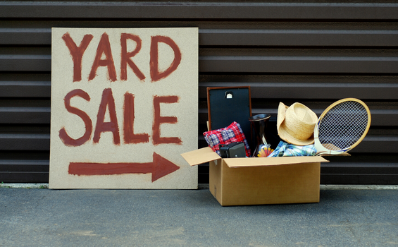 box of items with yard sale sign