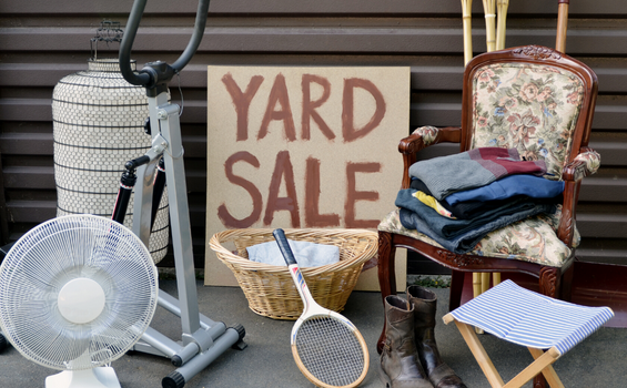 box of items with yard sale sign